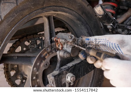 The process of replacing brake pads on a motorcycle. Maintenance motorcycles
