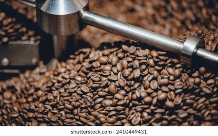 Process roasting brown coffee beans on professional mixing roaster industry machines