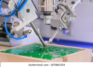 Process of selective soldering components to printed circuit boards at factory, exhibition - close up view. Automated technology, industrial, robotic, electronic, production, manufacturing concept