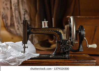 Process of sewing on the ancient sewing machine in the antiquarian case. Soft focus.