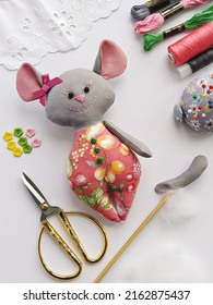 Process of stuffing soft toy stuffed animal textile mouse with synthetic wadding, flat lay