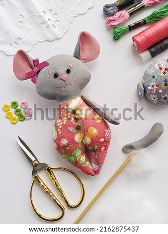 Process of stuffing soft toy stuffed animal textile mouse with synthetic wadding, flat lay
