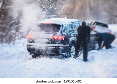 Process Of Taking Out Suv Car Stuck In Snow, Men Digging And Pushing The Car Out Of Snow, Concept Of Winter Problems With Car