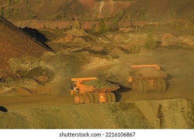 The Process Of Unloading A Large Dump Truck That Carries Minerals. The Technology Of Ore Mining, Raw Materials For Metallurgy.