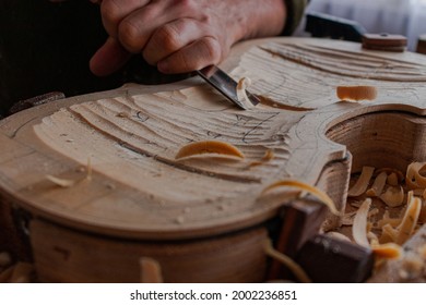Process where luthier use different tools to work wood and make a violin 