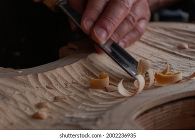 Process where luthier use different tools to work wood and make a violin 