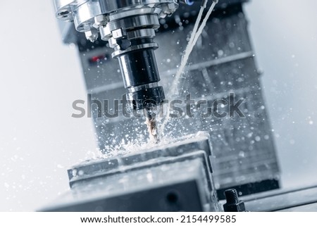 Process working CNC turning cutting milling metal Industry machine iron tools with splash water.