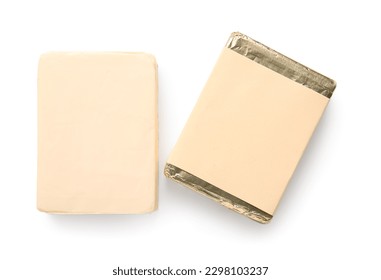 Processed cheese in foil isolated on white background