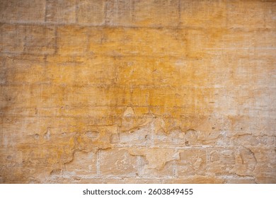 Processed collage of ancient yellow block wall texture. Background for banner, backdrop or texture for 3D mapping.A rectangular slab of light sandstone against the background of stone fragments as the