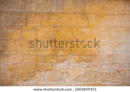Processed collage of ancient yellow block wall texture. Background for banner, backdrop or texture for 3D mapping.A rectangular slab of light sandstone against the background of stone fragments as the