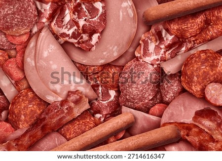 Processed Meats Background as an assortment of sliced and cured meat as deli style ham salami prosciutto, and hot dogs as cold cuts charcuterie.