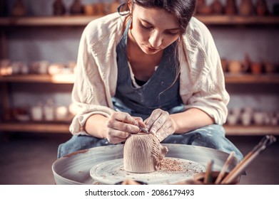 Processing clay ware and making dishes, process. Ceramics of handwork and clay ware on the potter's wheel.