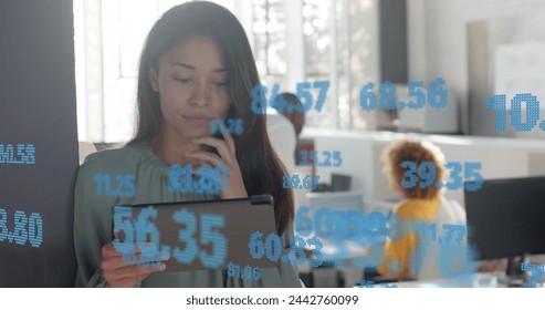 Processing data over happy biracial casual businesswoman using tablet at office. Casual business, data, digital interface, connection, office and communication digitally generated image. - Powered by Shutterstock