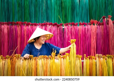 Processing of flax trees into different colors to be weaved into mats. One of the occupations and lifestyles of village people in rural Thailand.