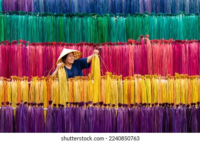 Processing of flax trees into different colors to be weaved into mats. One of the occupations and lifestyles of village people in rural Thailand.