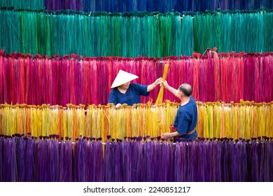 Processing of flax trees into different colors to be weaved into mats. One of the occupations and lifestyles of village people in rural Thailand.