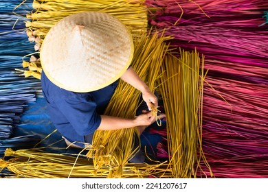 Processing of flax trees into different colors to be weaved into mats. One of the occupations and lifestyles of village people in rural Thailand.