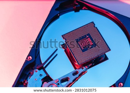 processing unit CPU microprocessor chip placed on opened computer hard disk drive HDD components as a conceptual metaphor for AI hardware semiconductor technology data storage infrastructure and cyber