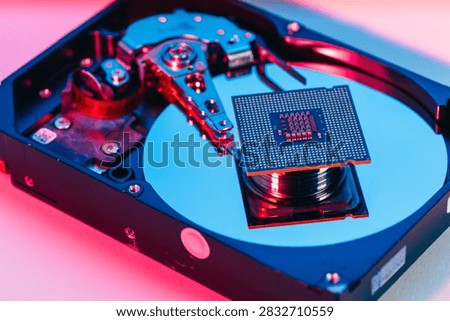 processing unit CPU microprocessor chip placed on opened computer hard disk drive HDD components as a conceptual metaphor for AI hardware semiconductor technology data storage infrastructure and cyber