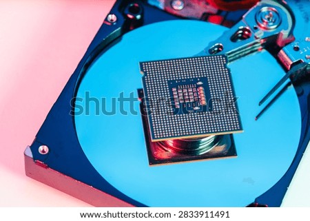 processing unit CPU microprocessor chip placed on opened computer hard disk drive HDD components as a conceptual metaphor for AI hardware semiconductor technology data storage infrastructure and cyber