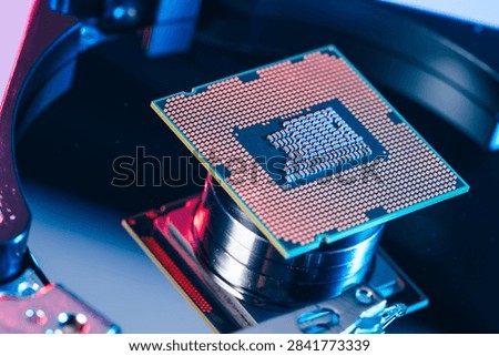 processing unit CPU microprocessor chip placed on opened computer hard disk drive HDD components as a conceptual metaphor for AI hardware semiconductor technology data storage infrastructure and cyber