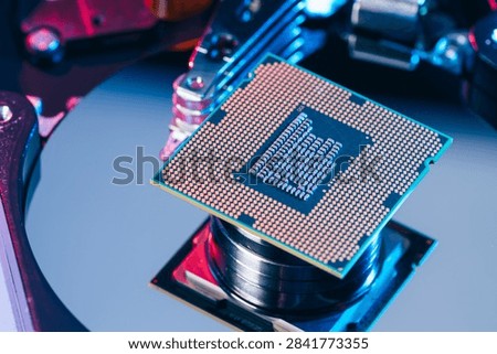 processing unit CPU microprocessor chip placed on opened computer hard disk drive HDD components as a conceptual metaphor for AI hardware semiconductor technology data storage infrastructure and cyber