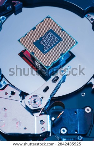 processing unit CPU microprocessor chip placed on opened computer hard disk drive HDD components as a conceptual metaphor for AI hardware semiconductor technology data storage infrastructure and cyber
