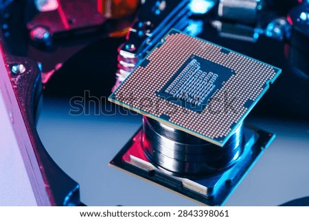 processing unit CPU microprocessor chip placed on opened computer hard disk drive HDD components as a conceptual metaphor for AI hardware semiconductor technology data storage infrastructure and cyber