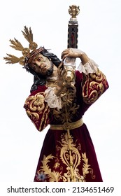 Procession of Jesus in the Holy Week of Spain, Andalusia, Granada. Holy week in seville. Painful face of crucified christ with cross on his back. phot vertical