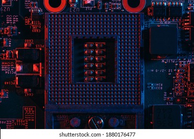 Processor socket in neon light. Motherboard with microchips. Dark photo.CPU processor.
