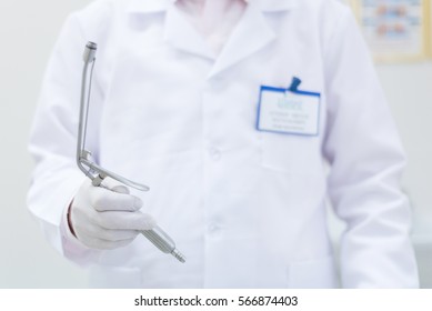 proctologist doctor holding Ligador hemorroidal in office