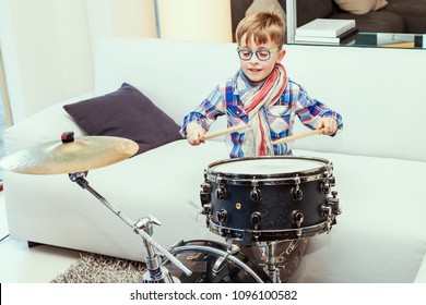 Prodigy Child Plays The Drums At Home In His Modern Apartment