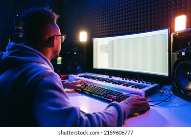 Producer, Audio Engineer Uses A Control Panel And Screen To Record A Track Of A New Album In A Recording Studio, In A Soundproof Room. Image Producer, Designer In Working Process