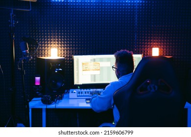 Producer, audio engineer uses a control panel and screen to record a track of a new album in a recording studio, in a soundproof room. Image producer, designer in working process - Shutterstock ID 2159606799