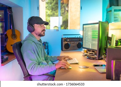 Producer Working In Sound Design Studio. Music, Film Score, Advertising Footage Digital Editing, Jingle Song, Voice Actor Recording, Post Production. Young Man Working With His Computer. Color Lights