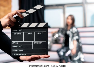 Producing Online Movies And TV Series. Focus On Clapper Board With Woman On Stage On Background. Movie Or Clip Production Backstage