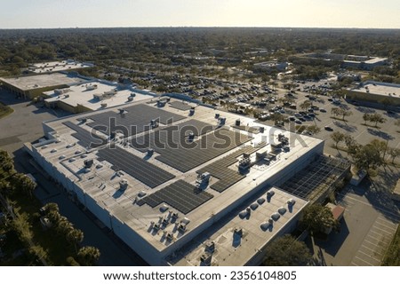 Producing of sustainable energy. Electric photovoltaic solar panels installed on shopping mall building rooftop for production of green ecological electricity