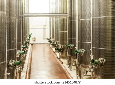 Producing Wine On A Large Scale. Shot Of The Fermentation Vessels Inside A Winemaking Factory.