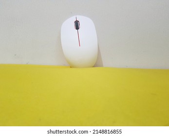 A Product Of Computer Equipment, Namely A Mouse. This Mouse Has A Pure White Color, With A Red Light Inside. This Photo Is Very Eye Catching For Your Product Template Background.