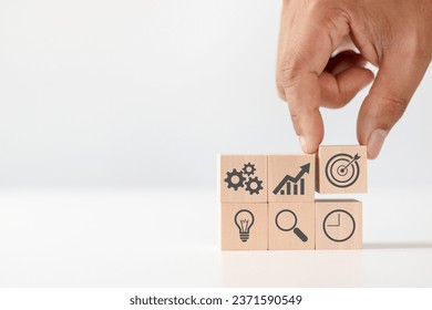 Product development, analysis and market validation. MVP, minimum viable product concept for lean startup. Hand arranging wooden cubes with icon new product launch, business strategy and Action plan.