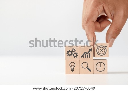 Product development, analysis and market validation. MVP, minimum viable product concept for lean startup. Hand arranging wooden cubes with icon new product launch, business strategy and Action plan.