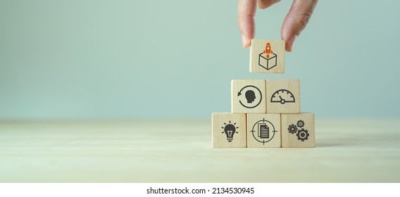 Product development and launching. MVP, minimum viable product concept for lean startup.  Analysis and market validation. Hand put wooden cubes with new product launch and learn, build, measure icons.