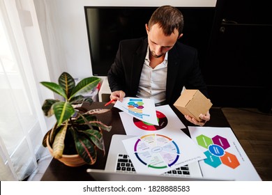 Product Marketing Manager Desk. Manager Holding New Product And Developing New Marketing Strategy Plan For Customers.