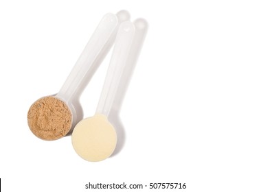 Product photograph of scoop of whey protein with visible texture. Image taken from above, top view