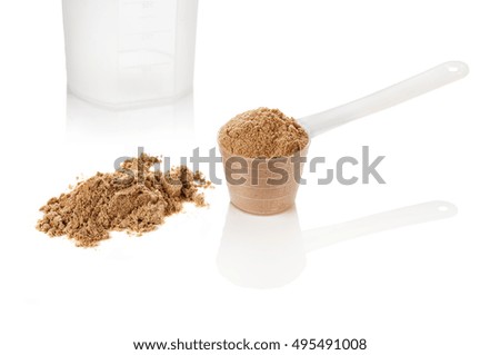 Product photograph of scoop of whey protein with visible texture and mirror reflection