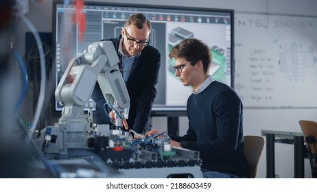 Product Supervisor Consults Young Engineer Working with Optimization of Robot Arm. People Doing Robotic Hand Maintenance Ideas. High-Tech Science and Engineering Concept. Medium Shot - Shutterstock ID 2188603459