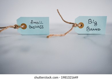 Product Tags With Small Business Vs Big Brand Texts Side By Side Sho At Shallow Depth Of Field, Concept Of Customer Behaviour And Supporting Small Businesses