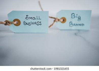 Product Tags With Small Business Vs Big Brand Texts Side By Side Sho At Shallow Depth Of Field, Concept Of Customer Behaviour And Supporting Small Businesses