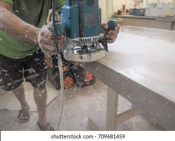 The Production Of Acrylic Worktops At A Furniture Factory. A Worker Produces Acrylic Countertops At The Factory. A Worker Polishes The Surface.