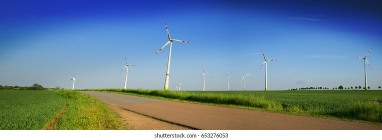 Production of alternative energy wind turbine on the Sunset,panoramic image 
 - Shutterstock ID 653276053